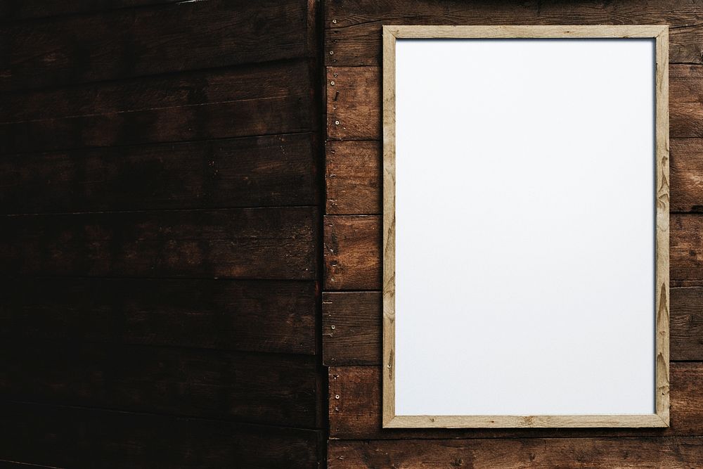 Blank wooden frame on brown brick wall