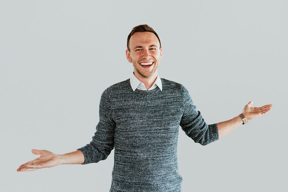 A business man smiling with arms outstretched