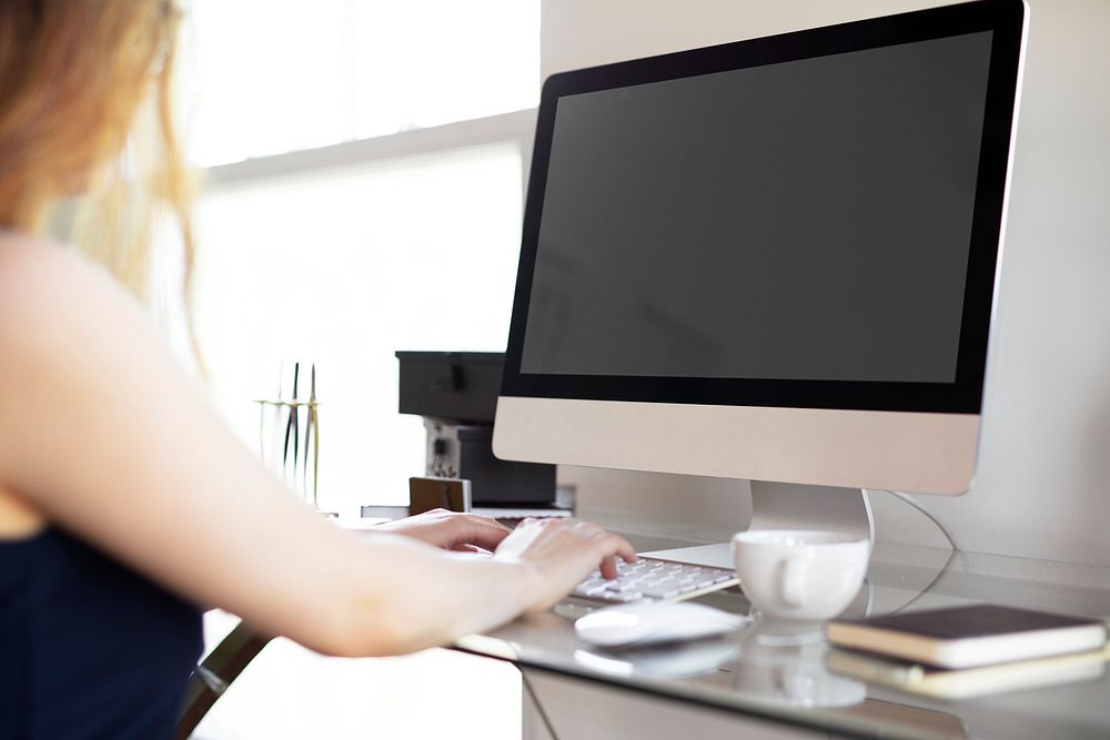 Woman using a computer at the desk