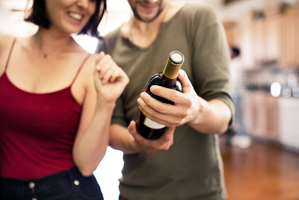 Couple receiving a bottle of red wine