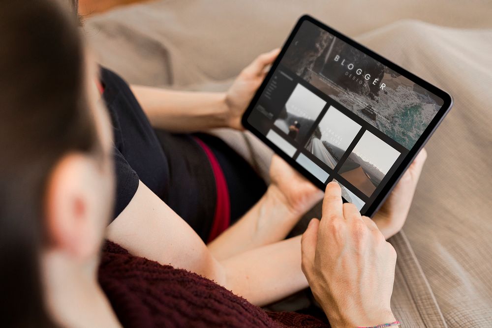 Couple using a tablet screen mockup together in bed