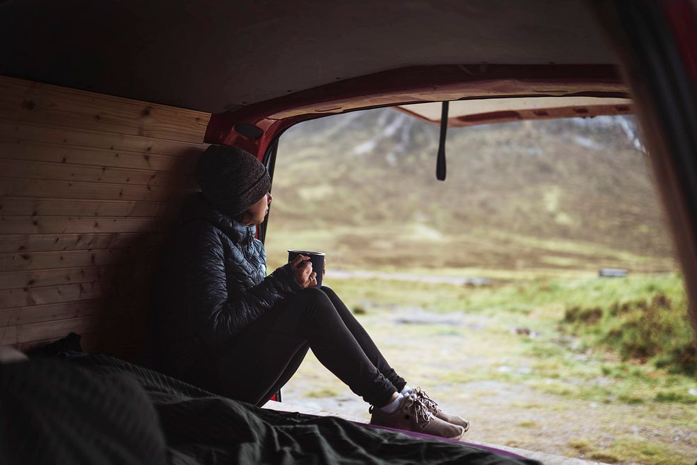 Woman in a camper with a cup of coffee