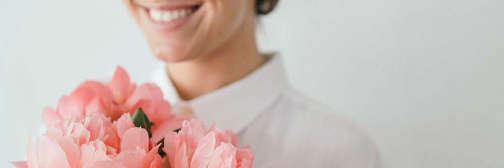 Happy woman holding a bouquet of peonies