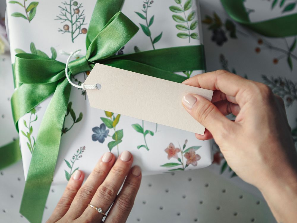 Gift box wrapped with floral patterned paper with a card
