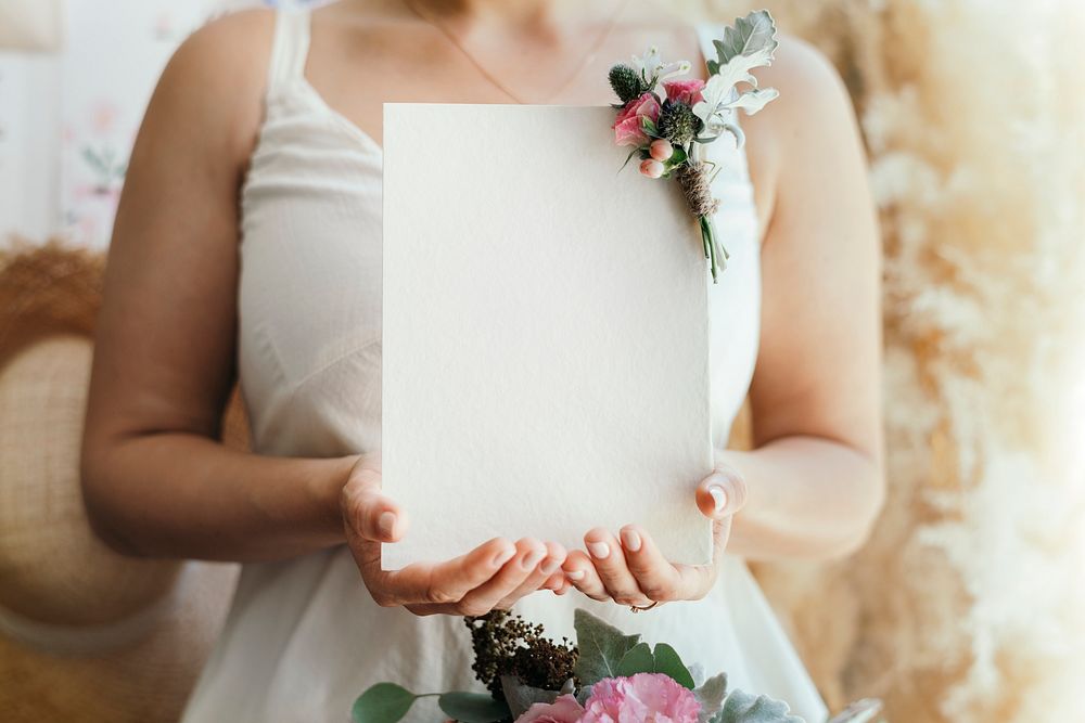 Bride holding a blank white card