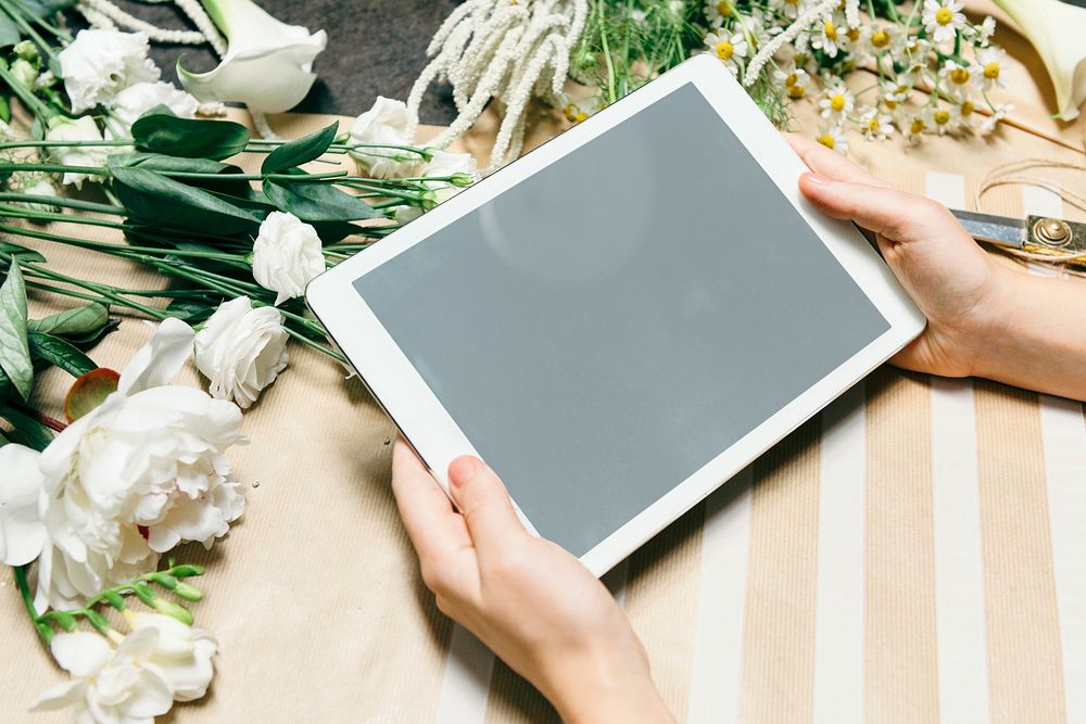 Florist using a digital tablet