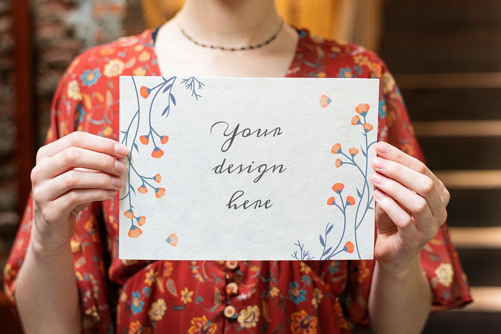 Woman holding a floral card mockup
