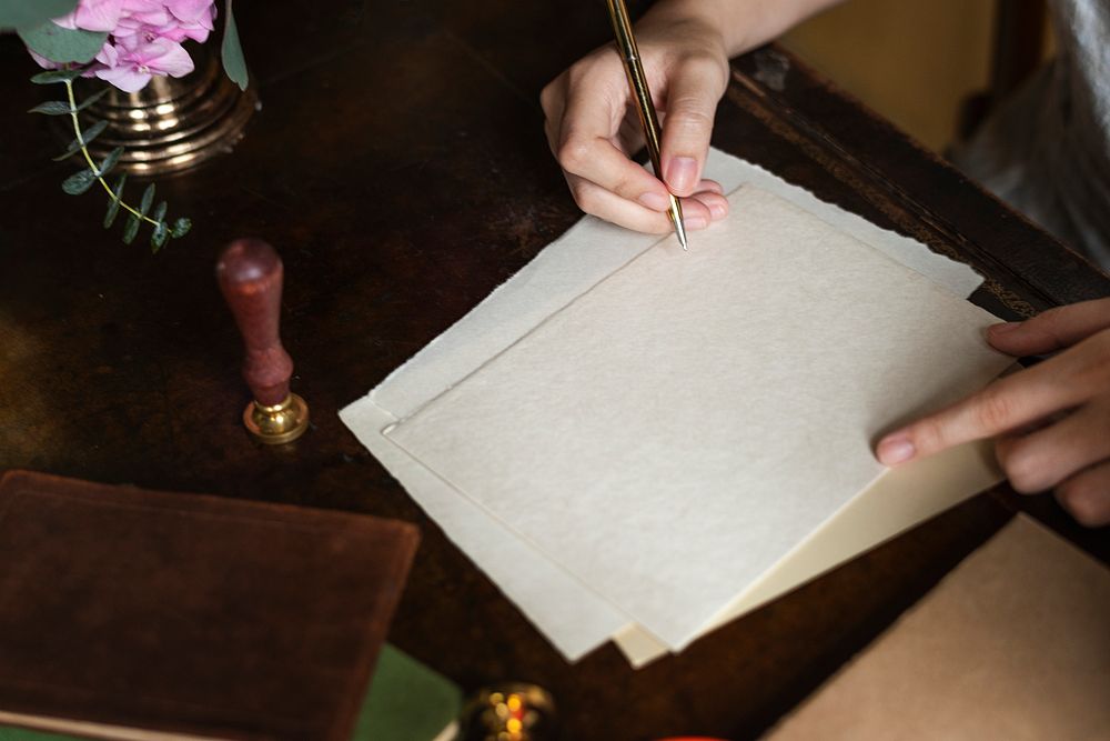 Woman writing a letter on a blank paper