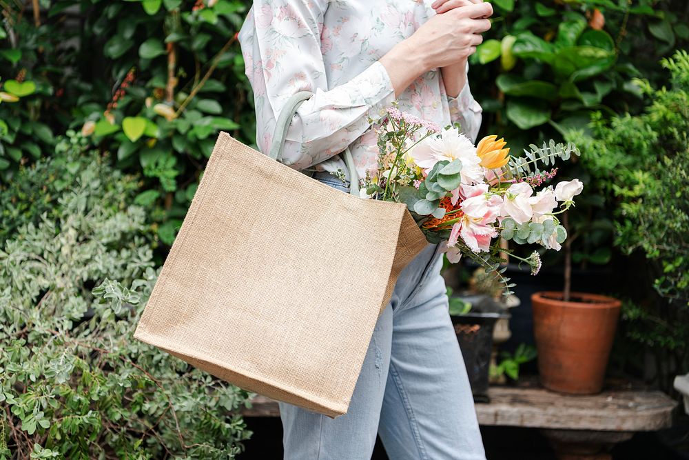 Woman with various flowers inside a bag