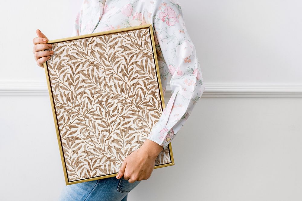 Woman holding leafy picture frame