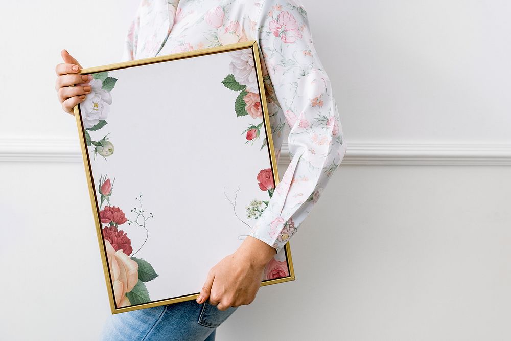 Woman holding a floral frame