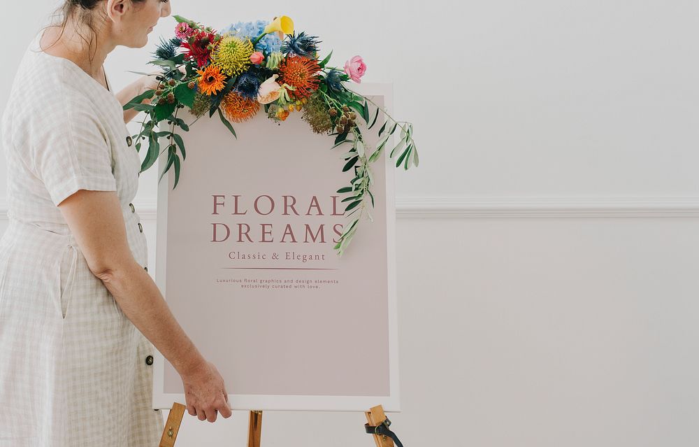 Woman standing by a floral dreams frame