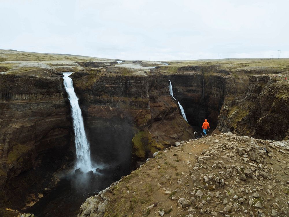 Drone shot of a man at the Haifoss waterfall, Iceland
