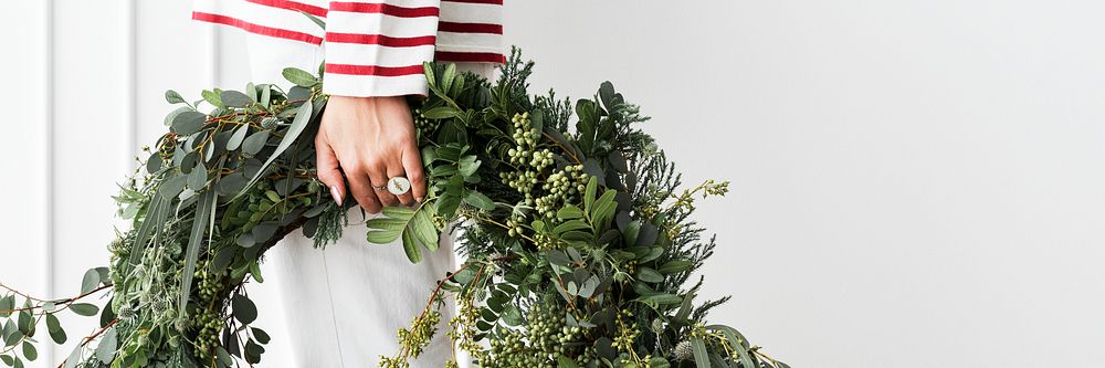 Woman carrying a fresh Christmas wreath social template