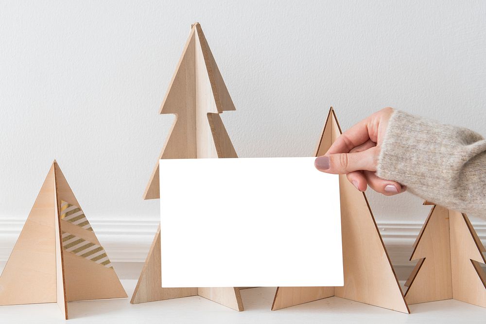 Greeting card in front of a paper Christmas tree