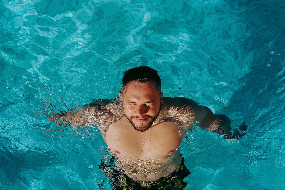 Man floating in a pool