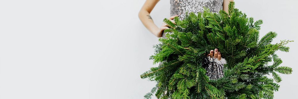 Woman holding a green Christmas wreath social template
