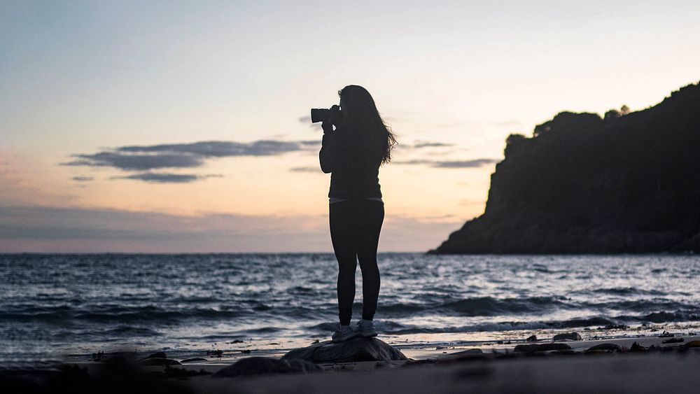 Female photographer capturing the sunset at Portelet Bay, Isle of Jersey