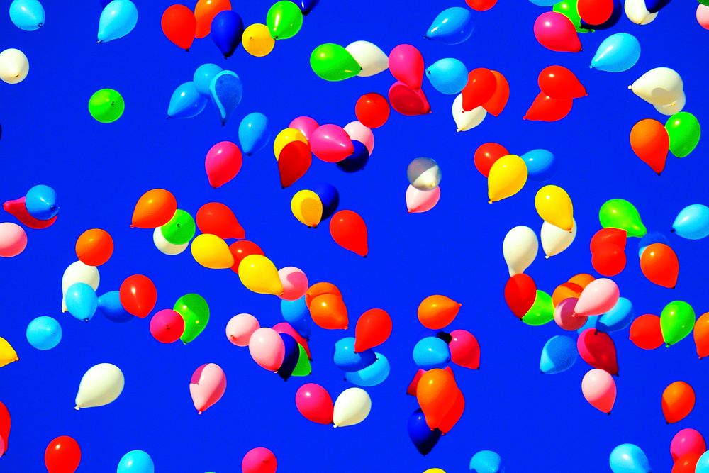 Colorful balloons background, floating in a blue sky