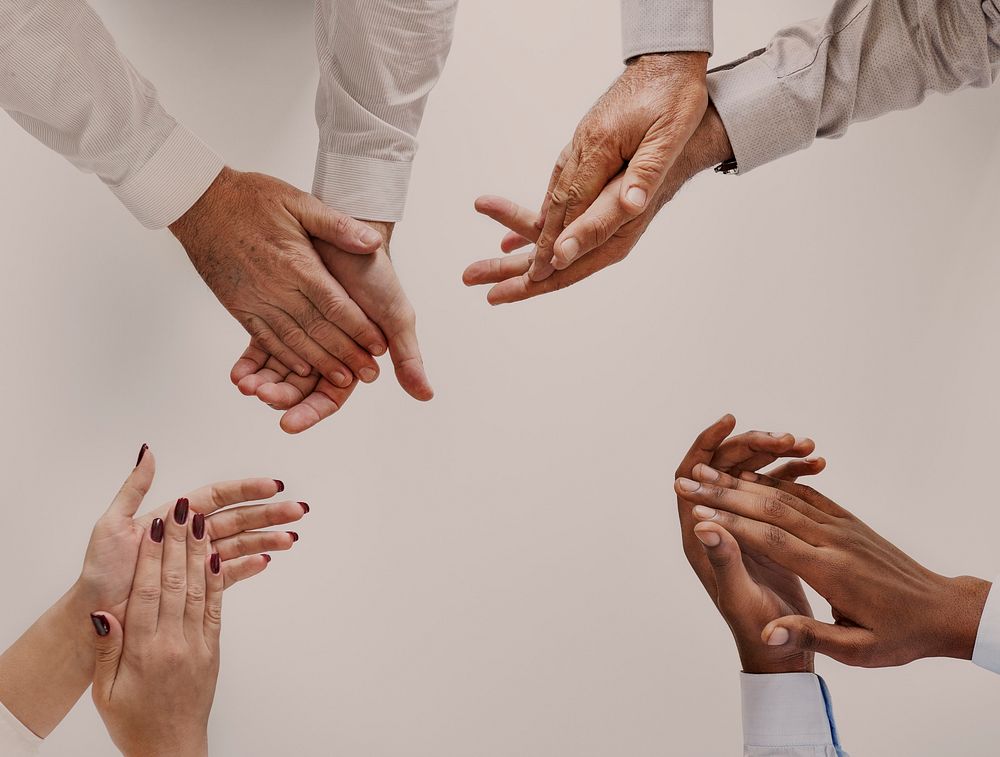 Diverse business people clapping hands, teamwork photo