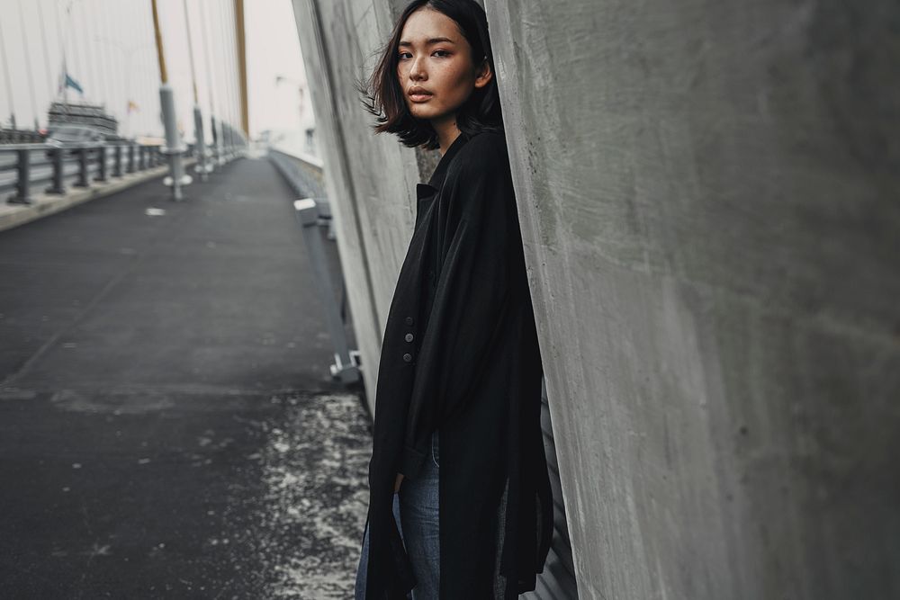 Asian woman in black coat, street fashion