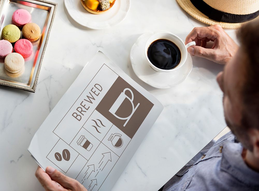 Man drinking coffee with Illustration of coffee shop advertisement on newspaper