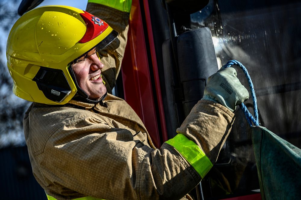 Firefighter pulling rope, March 6, 2019, Cheshire, UK. Original public domain image from Flickr