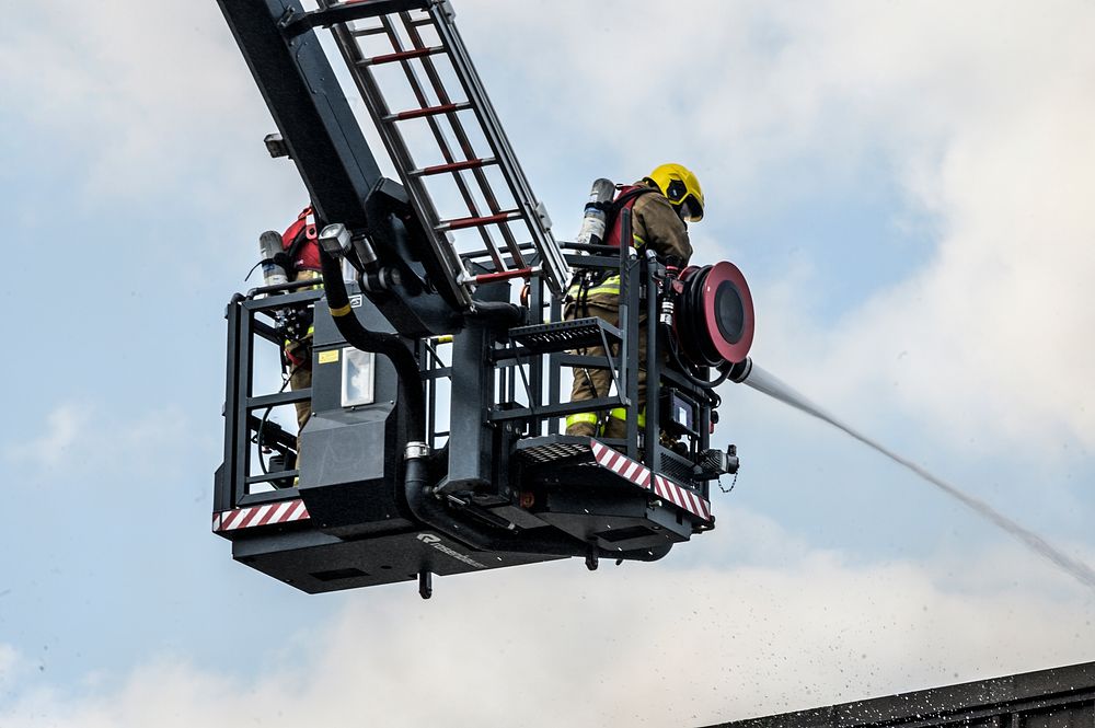 Firefighters on crane, April 29, 2019, Cheshire, UK. Original public domain image from Flickr