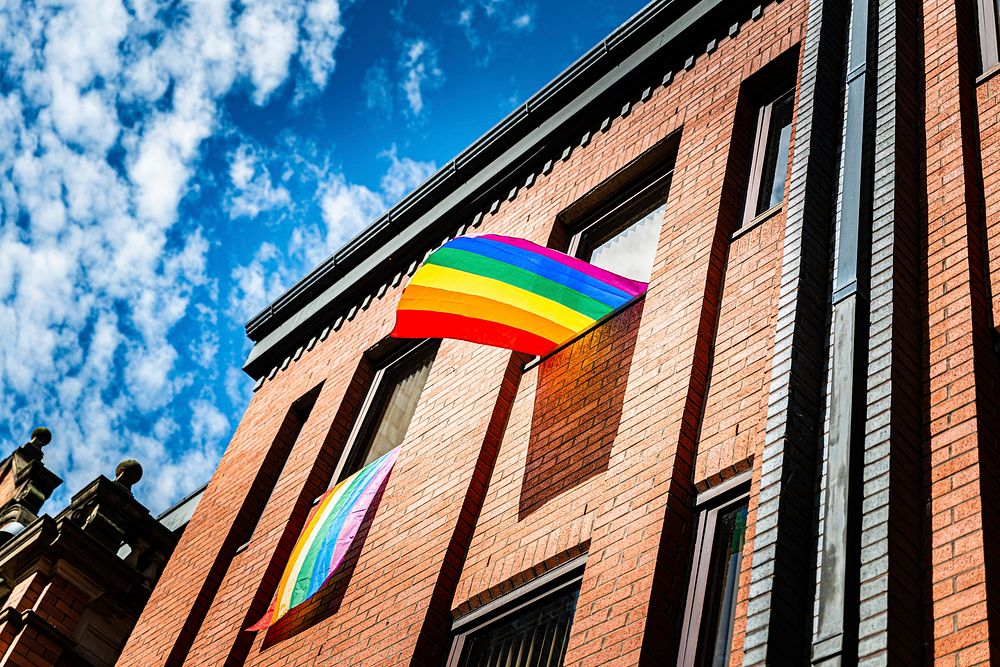 Pride flag on building. Original public domain image from Flickr