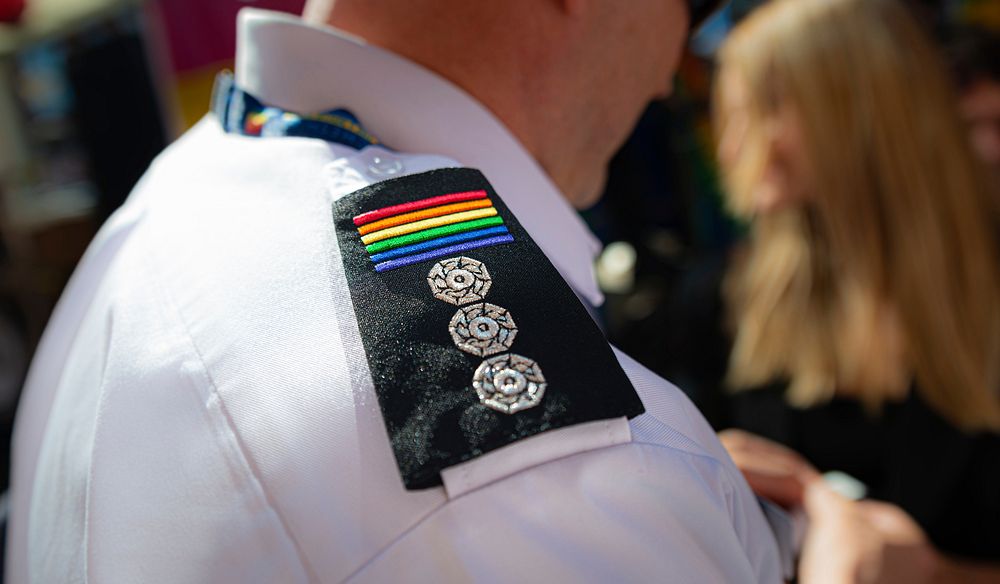 Rainbow shoulder badge, August 24, 2019, Manchester, UK. Original public domain image from Flickr