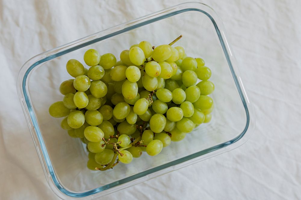 Bunch of green grapes in a glass bowl