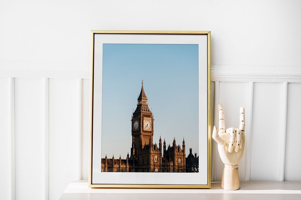 Big Ben photo frame by hand mannequin on white table