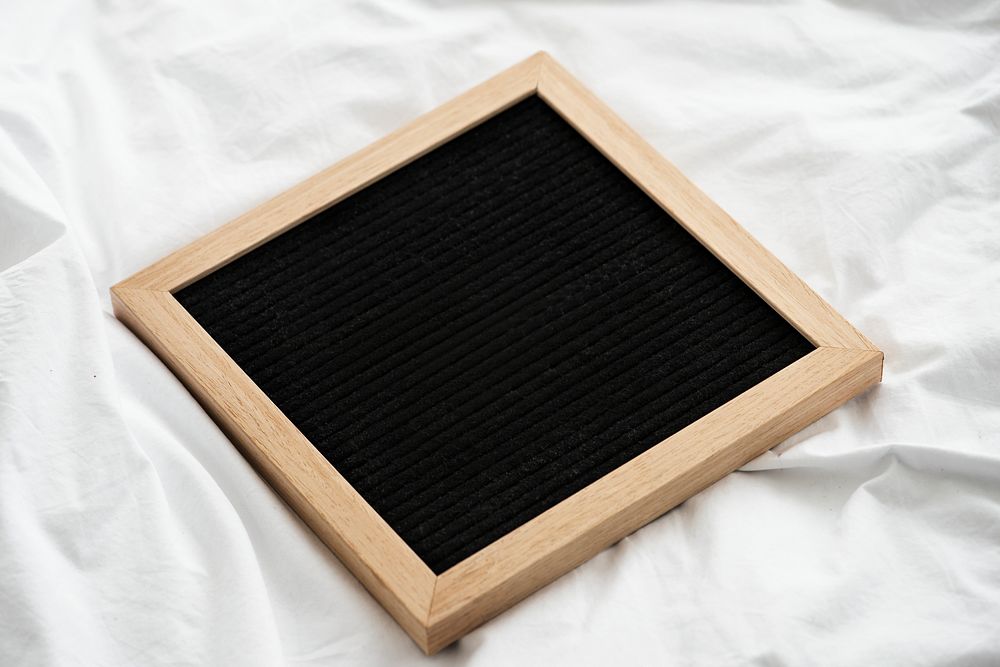 Blank wooden frame on a white sheet