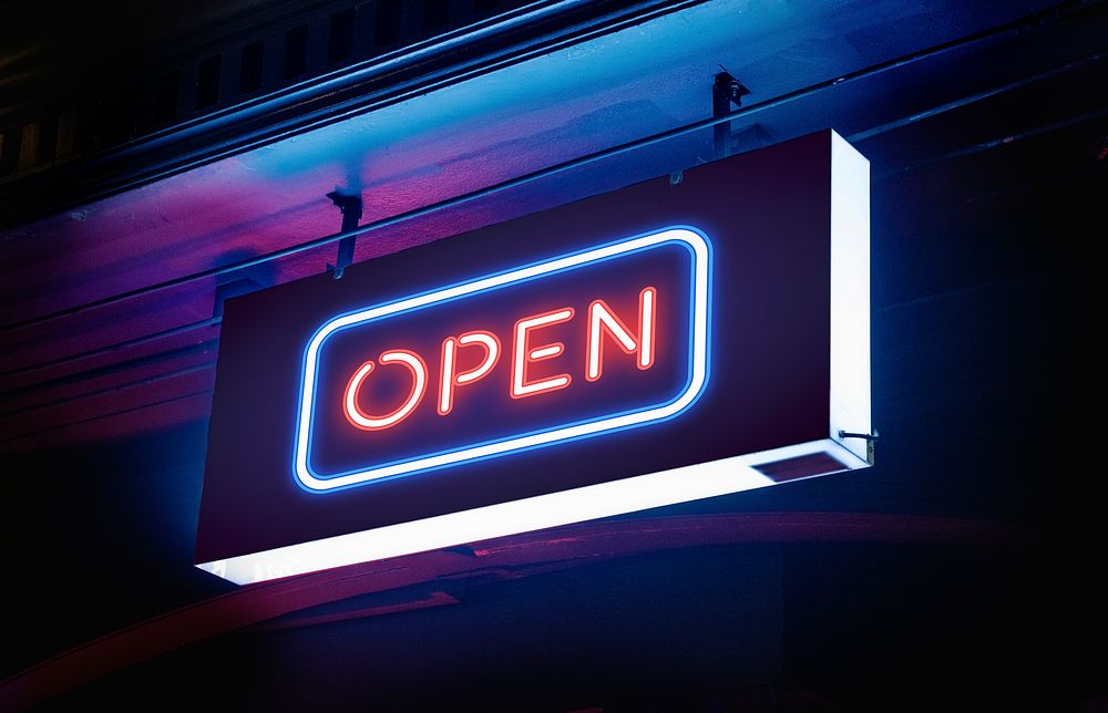 Open word signage in neon lights