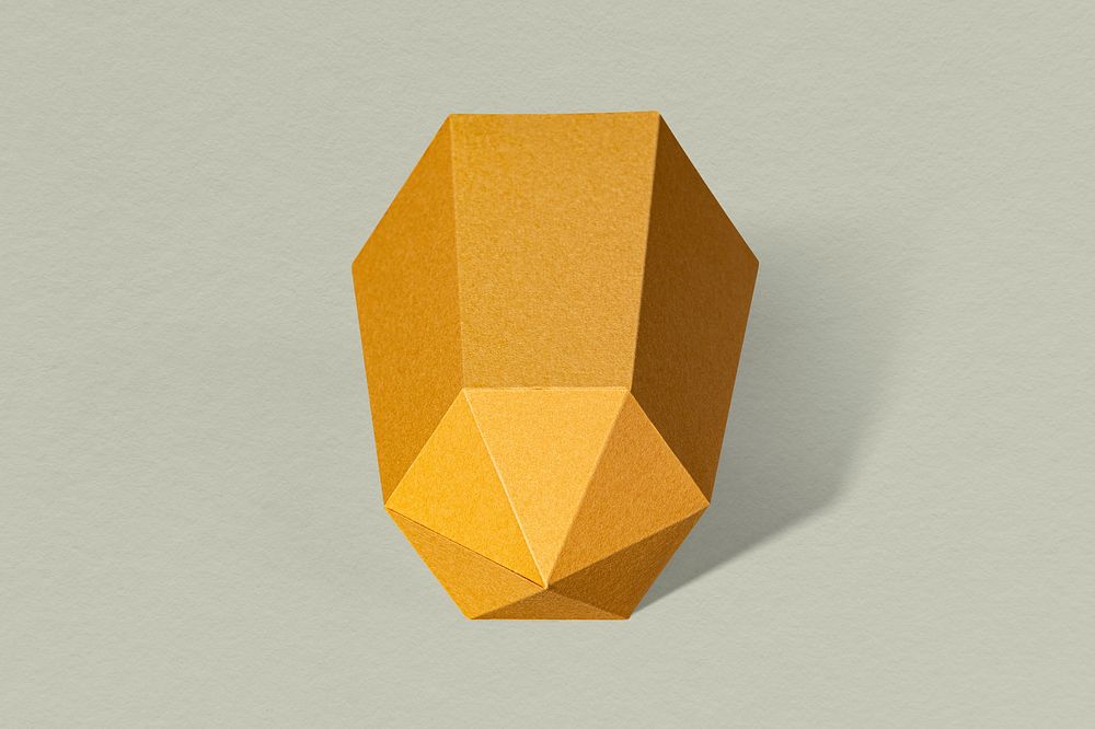 Golden hexagonal prism paper craft on a sage green background