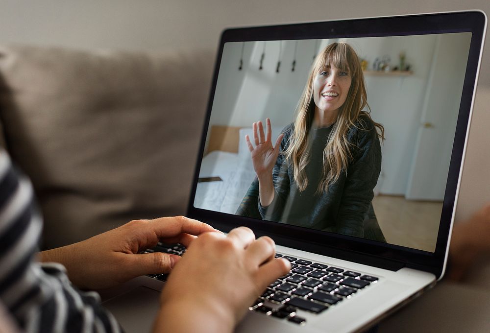 Woman using laptop, video calling photo