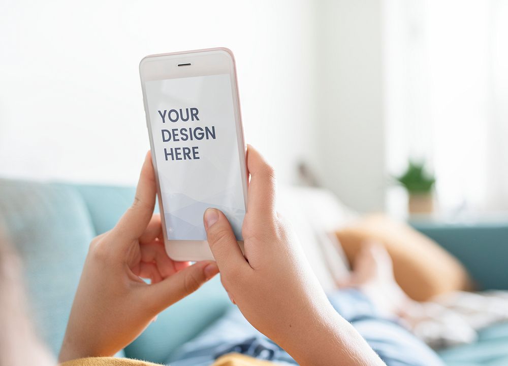 Woman using a phone mockup on a sofa