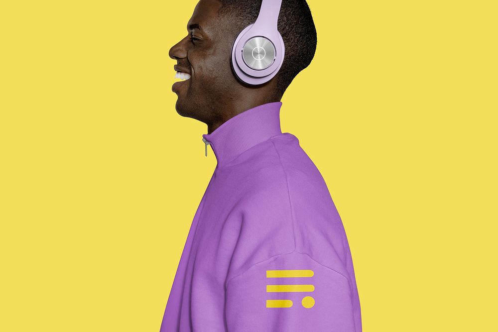 Man listening to music, wearing purple sweater 