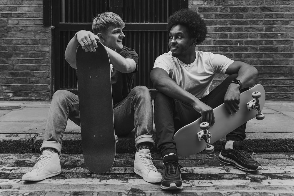 Men skateboarders hanging out, hobby photo in black and white