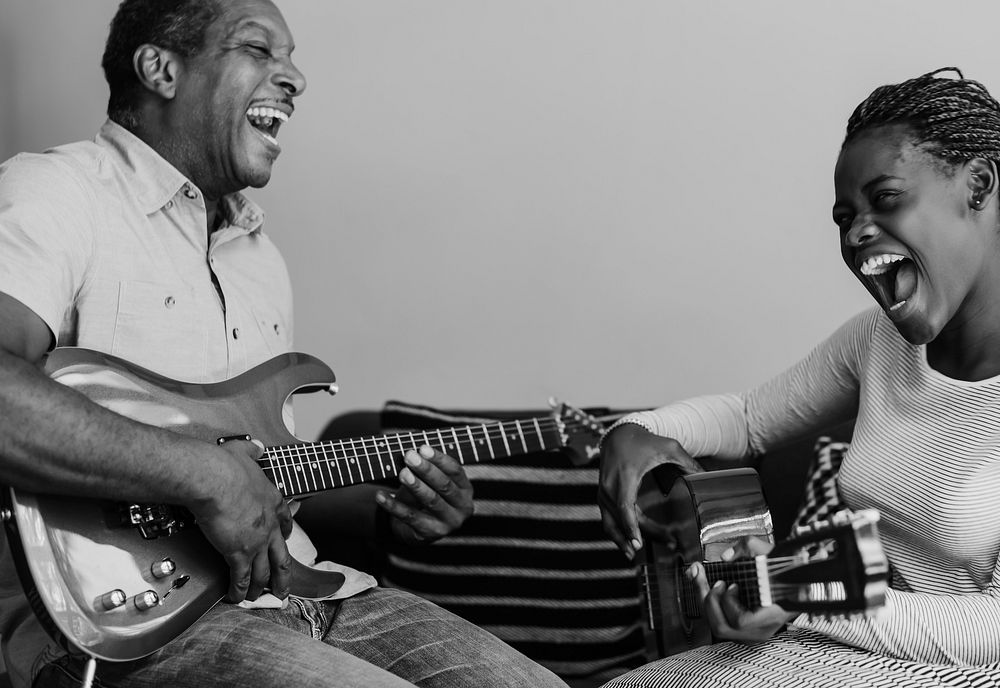 Father and daughter playing guitar, black and white photo