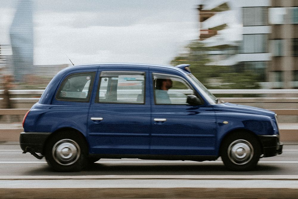 Blue vintage taxi in motion