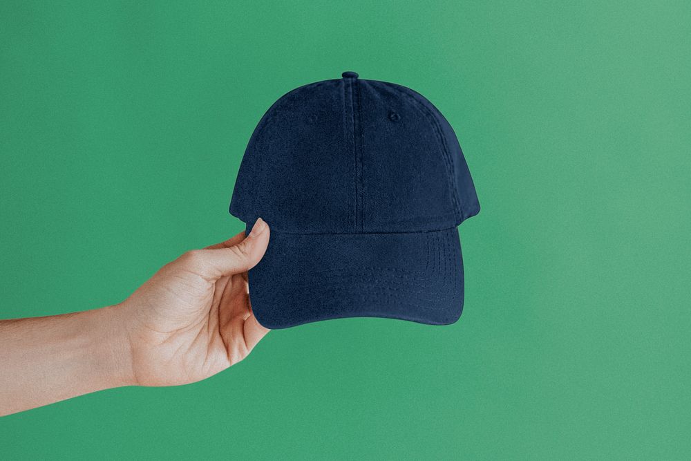 Hand holding blue cap, street fashion