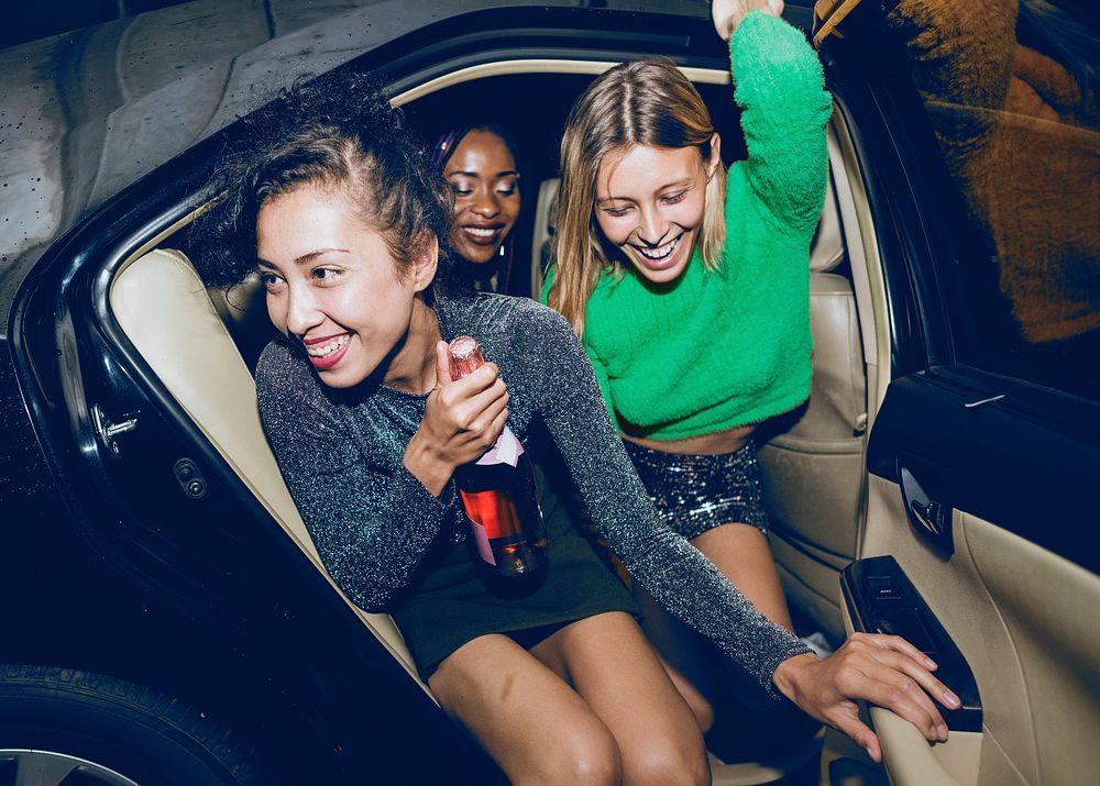 Diverse women in cab backseat 