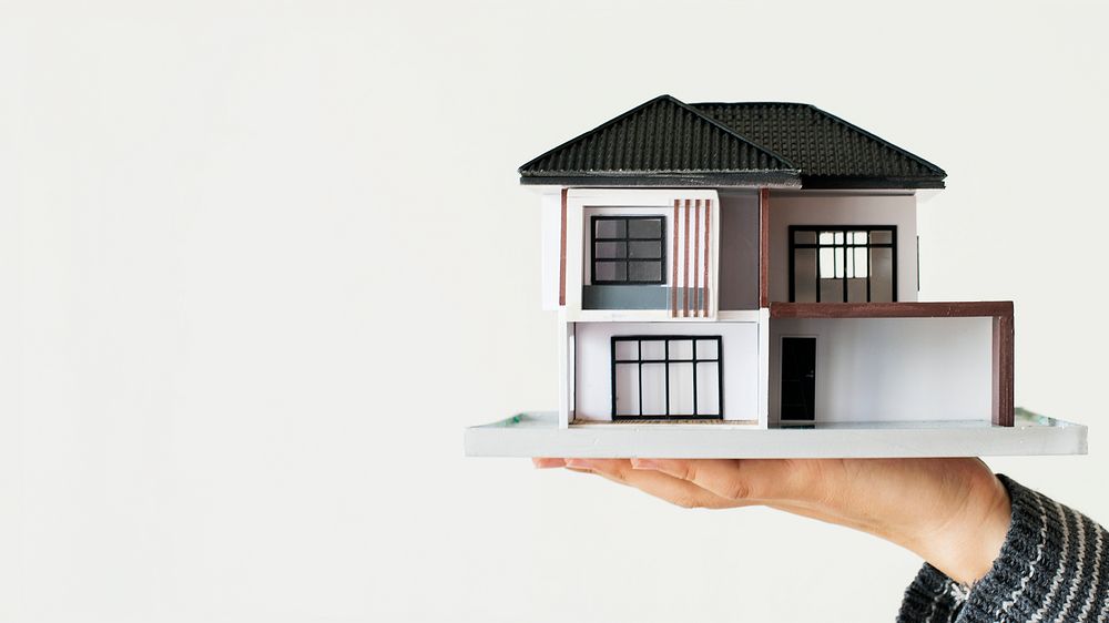 Home loan desktop wallpaper, hand holding house model