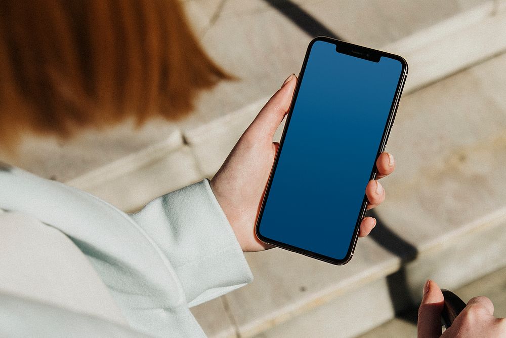 Woman using phone, blue screen mobile