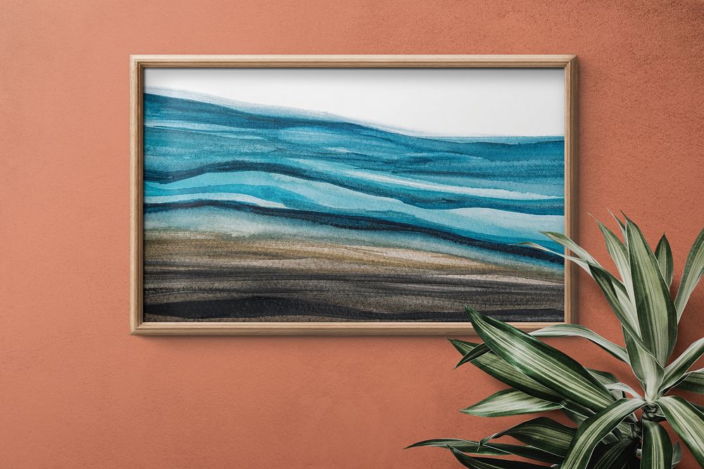 Framed watercolor ocean painting on a wall