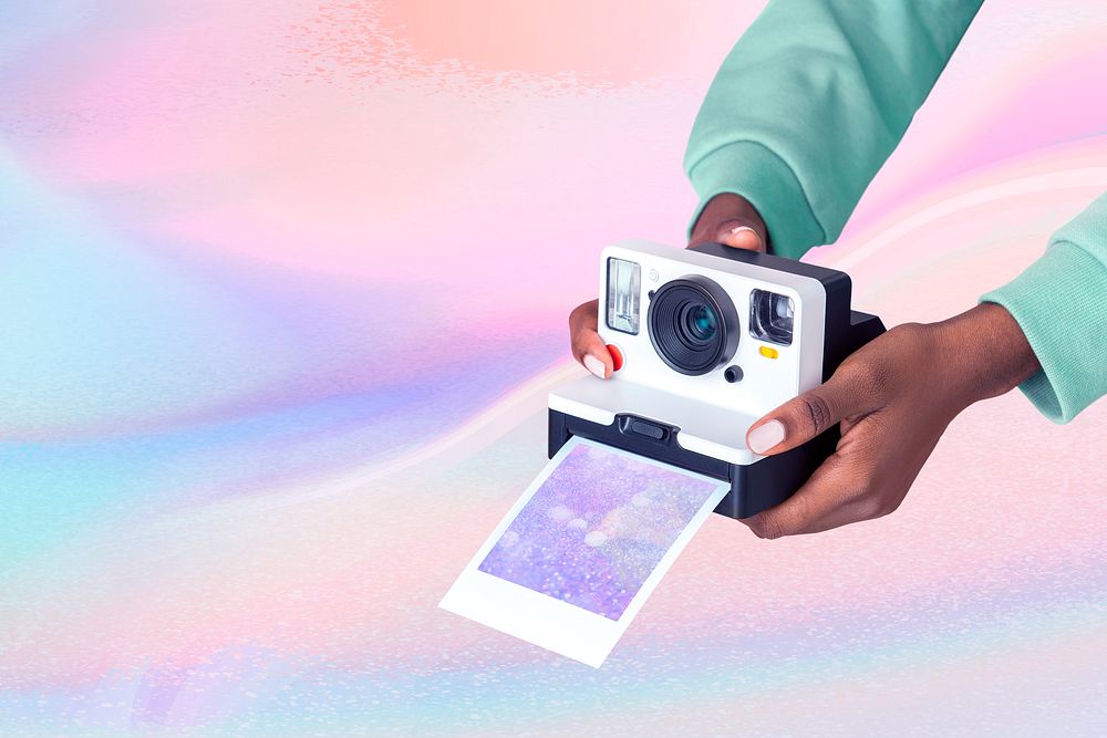 Hands holding Instant photo camera, iridescent design