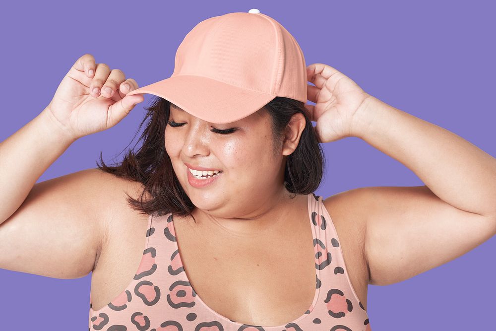 Plus-sized woman wearing pink cap, swimwear fashion