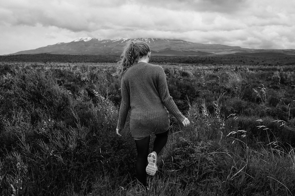 Woman walking in nature, gray photo