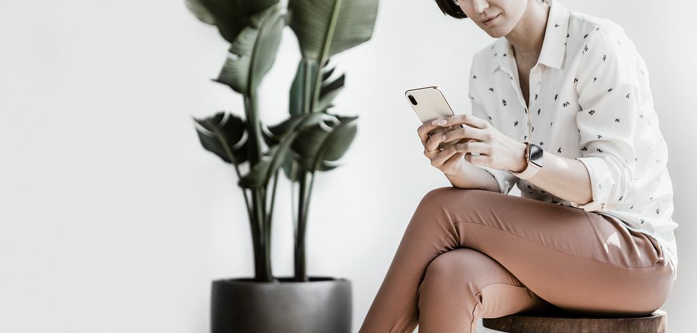 Businesswoman sitting, using mobile phone
